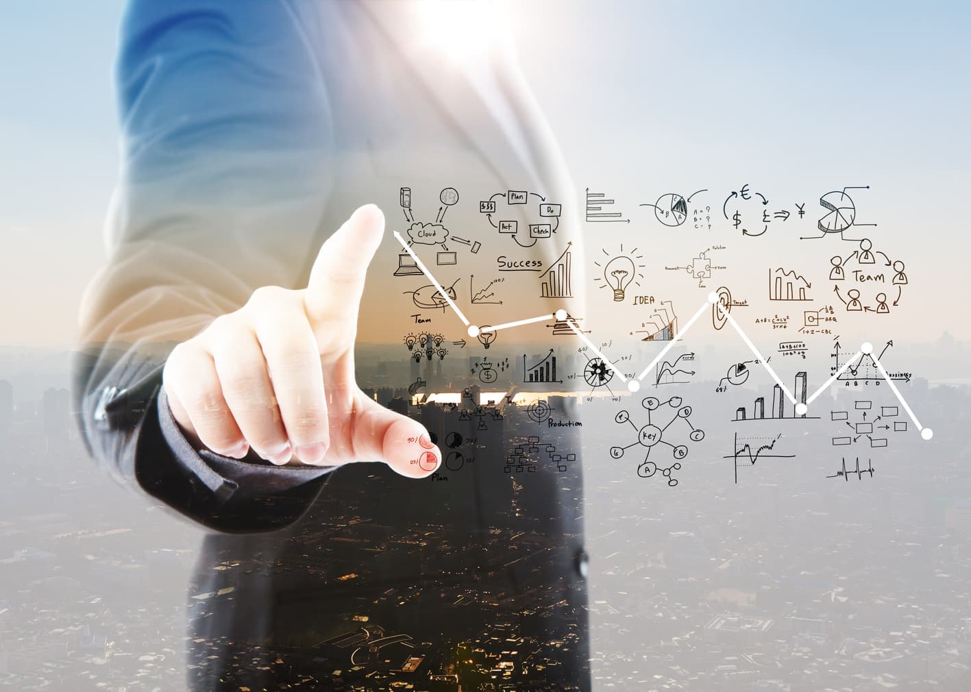 businessman-pointing-graphs-and-symbols.jpg